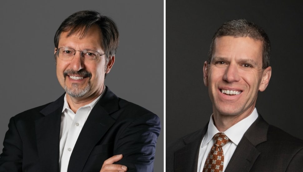 Headshots of two male middle-aged business executives in dark suits.