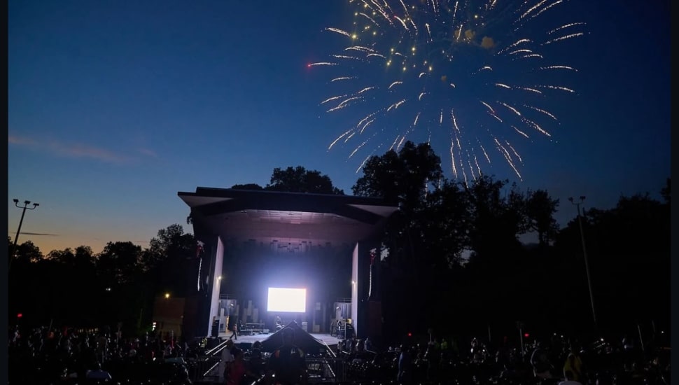 Fireworks burst over an outdoor concert venue in Philadelphia during a summer celebration.
