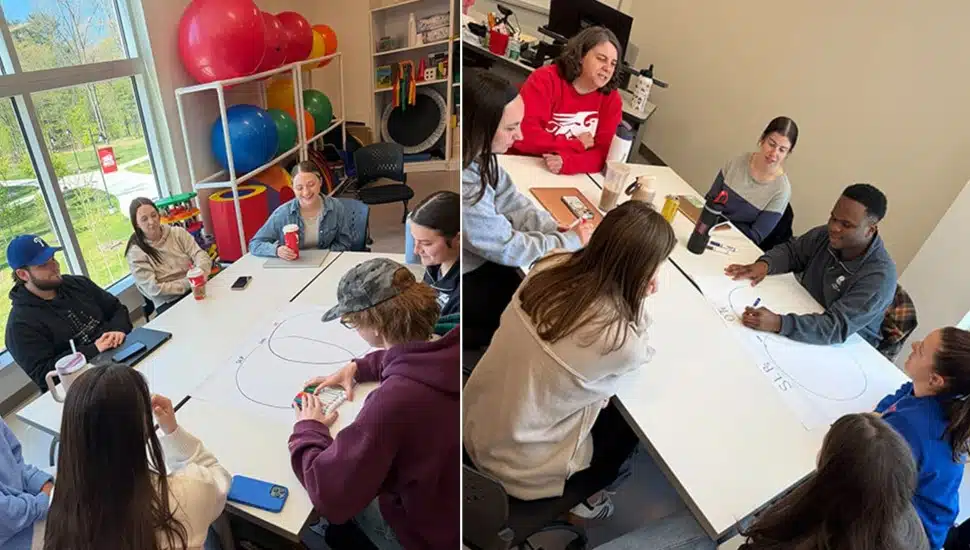 College students work in small groups at tables.