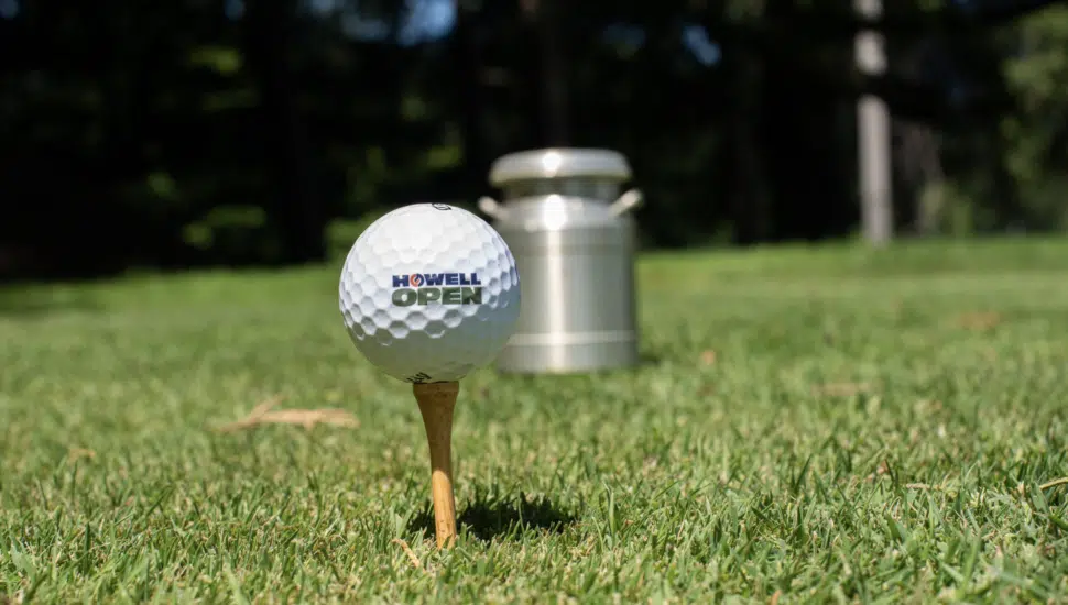 A Howell Engineering-branded golf ball on a tee.