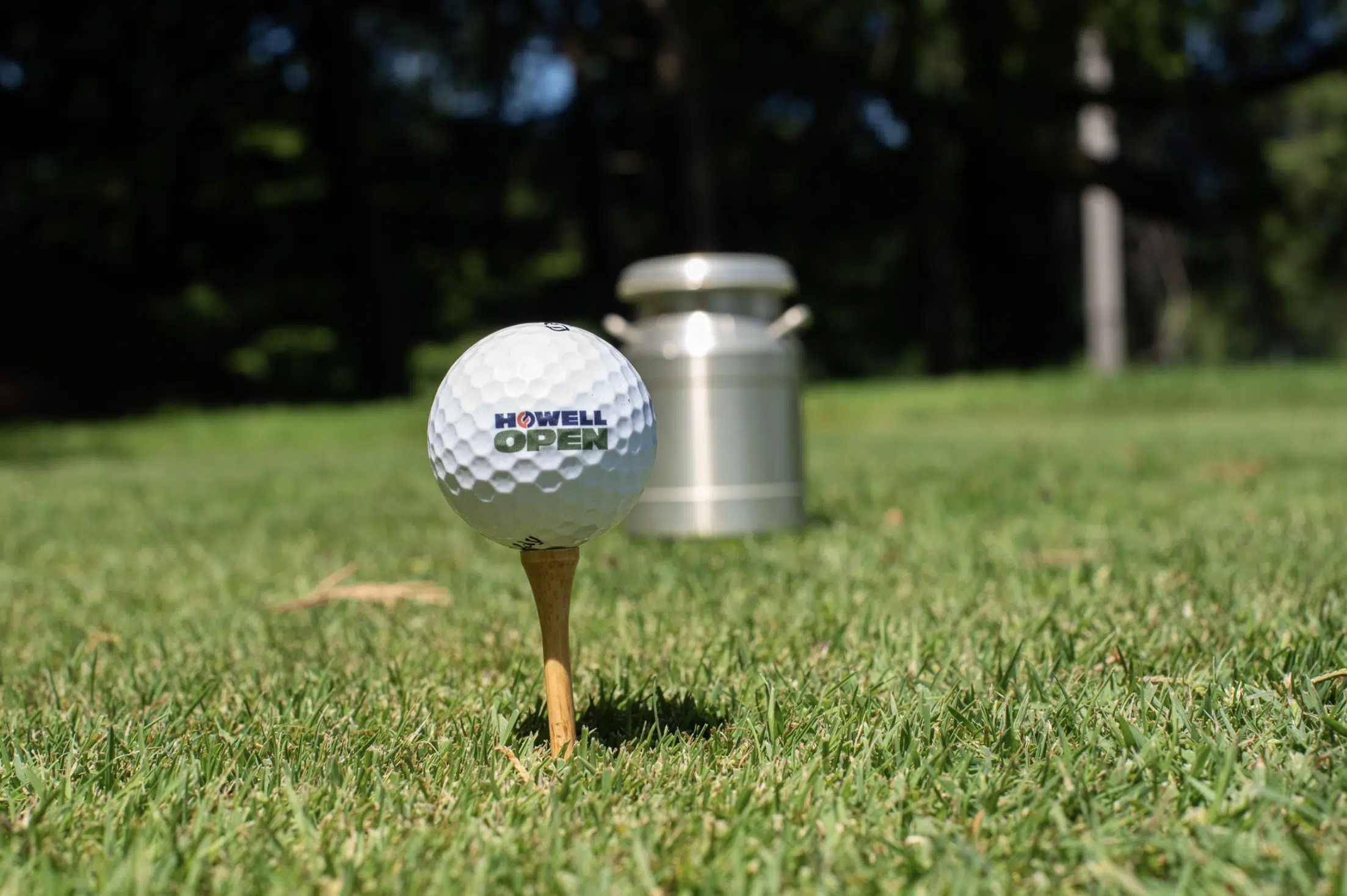 A Howell Engineering-branded golf ball on a tee.