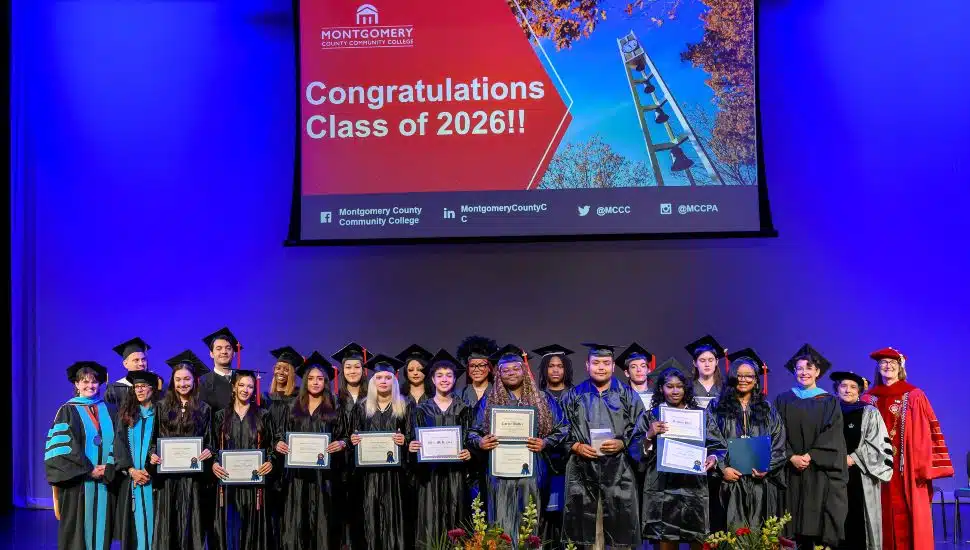 Students of MCCC stage in caps and gowns.