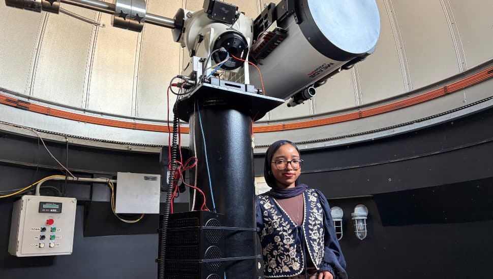 Loujain Ahmed, the Montgomery County Community College 2026 Commencement student speaker, stands in the observatory on the Blue Bell Campus.