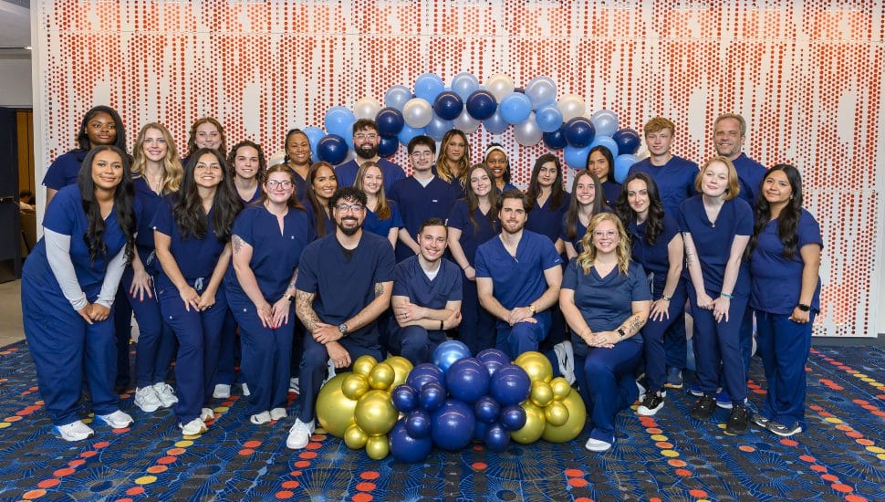 Nurses gathered for group picture with balloons after graduation.