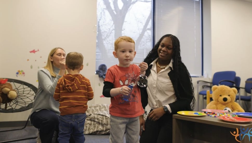 CCRES staff members work with two children.