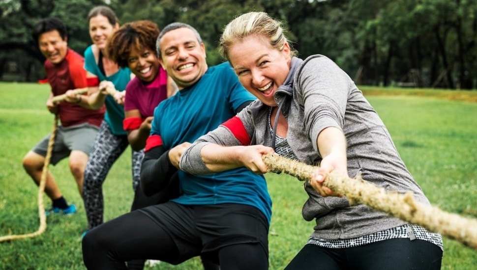 Adults play tug of war.