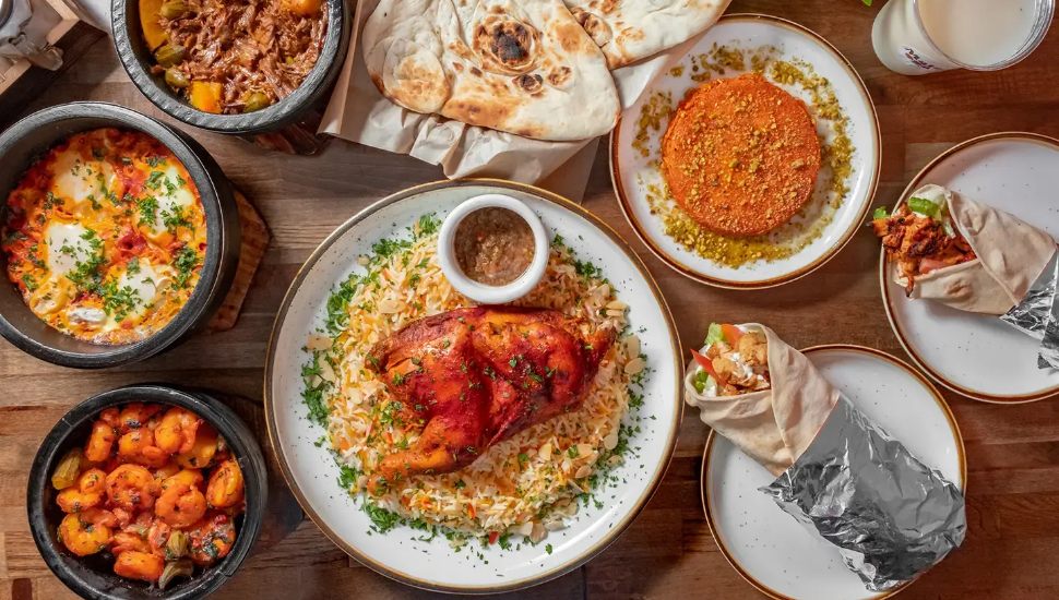 A table spread with a variety of dishes at Malooga.