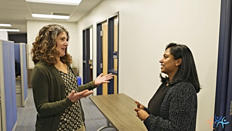 CCRES HR recruiter Mercy Alex (left) speaks with a co-worker
