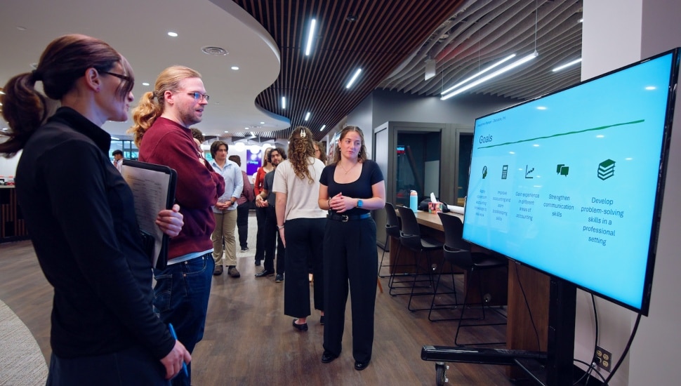Ursinus College students gather around a presentation to discuss their career goals.