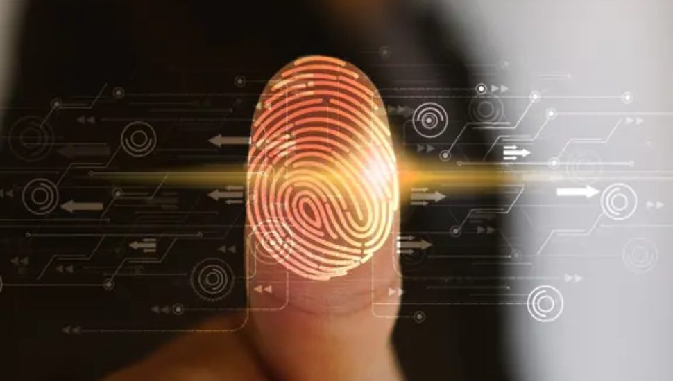A close-up of a finger with a glowing digital fingerprint scan overlay, representing identity verification and cybersecurity.